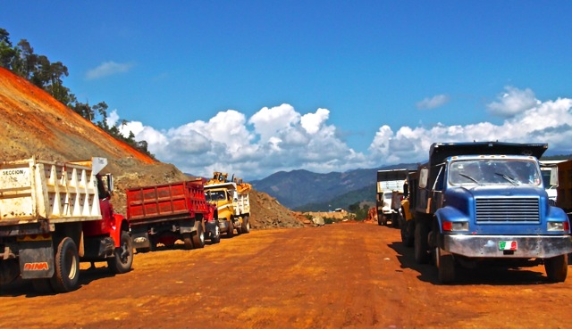 Trucks carrying excavation